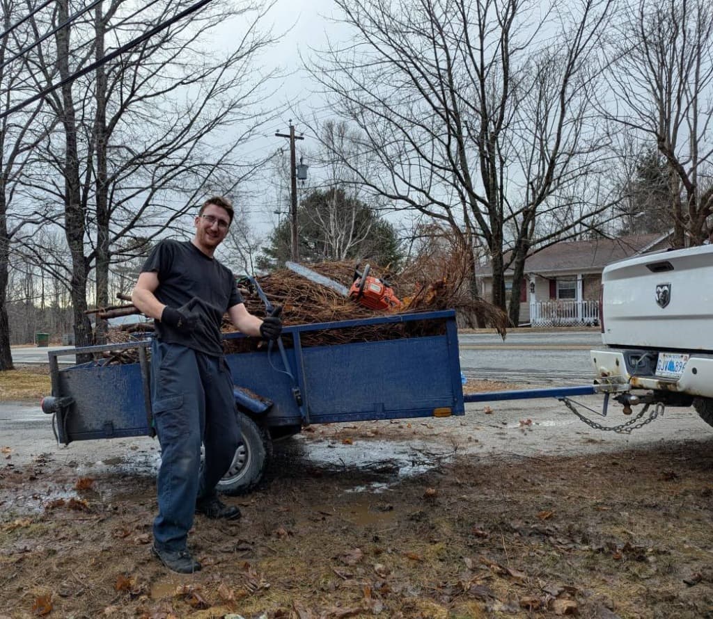 team member performing yard maintenance on a residential lawn